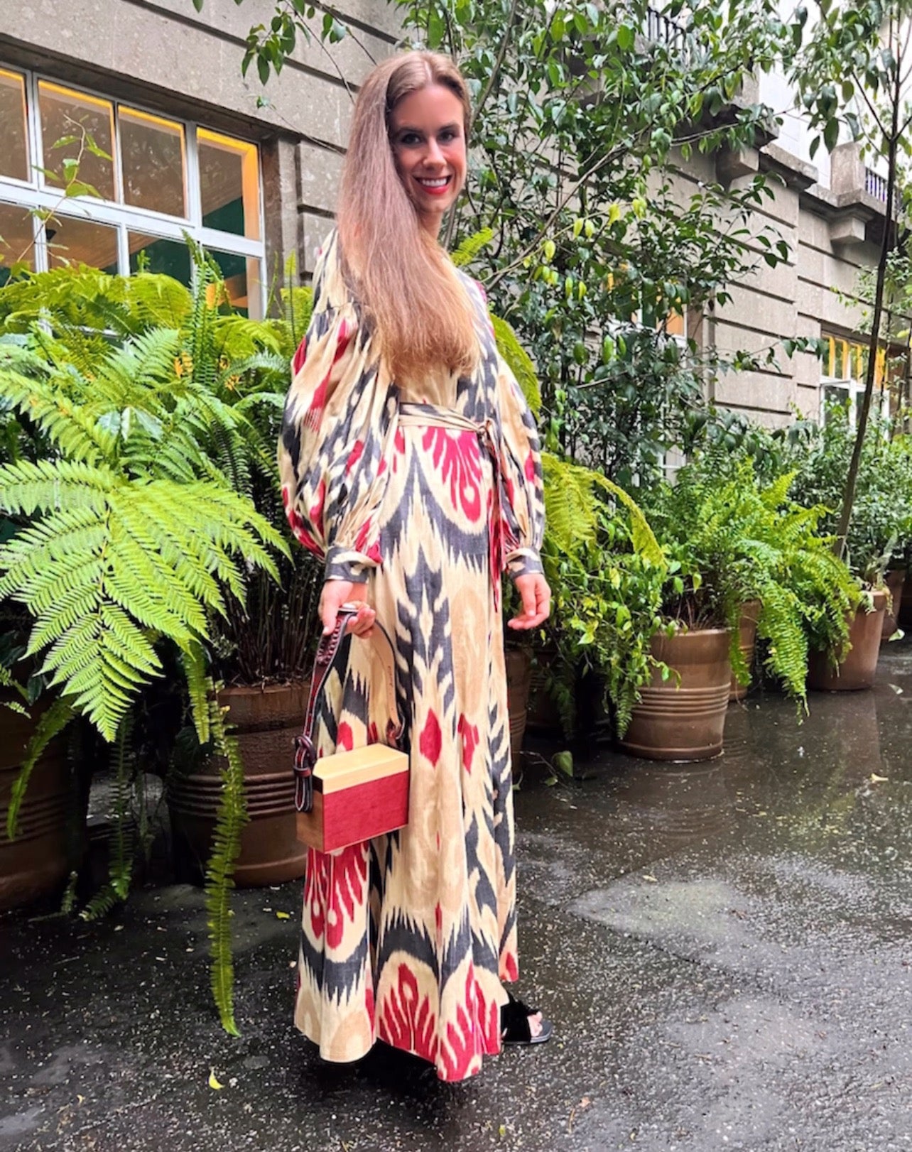 A photo of Haley Schultheis outside wearing a red, black, and ream printed dress